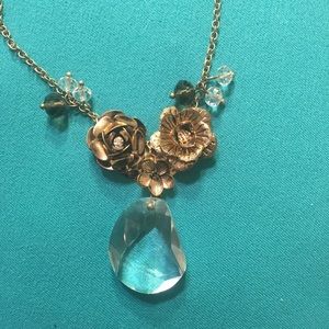 Gold flower necklace with clear pendant